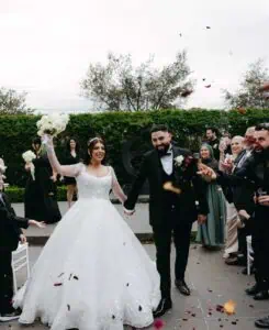 Melbourne marriage celebrant wedding ceremony exit at Meadowbank with bride and groom walking through guests