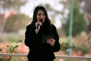 Melbourne marriage celebrant Gee from Gee What a Wedding delivering an outdoor wedding ceremony with microphone