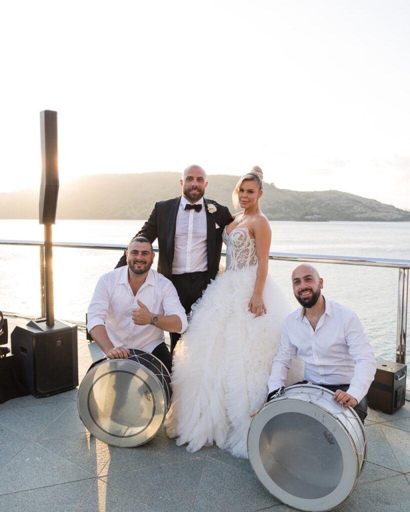 Bride and groom with Arab drummers at a Hamilton Island sunset reception, destination wedding day management and coordination by Melbourne wedding planner Gee What a Wedding